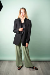 oversized unisex tuxedo blazer in black worn with pistachio pants